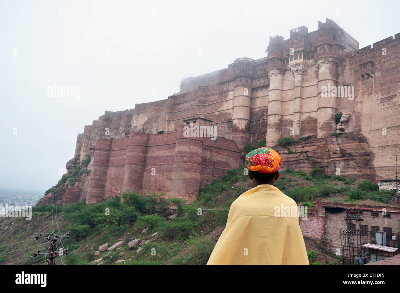 Man with colourful turban staring Mehrangarh Fort Jodhpur Rajasthan India Asia Stock Photo