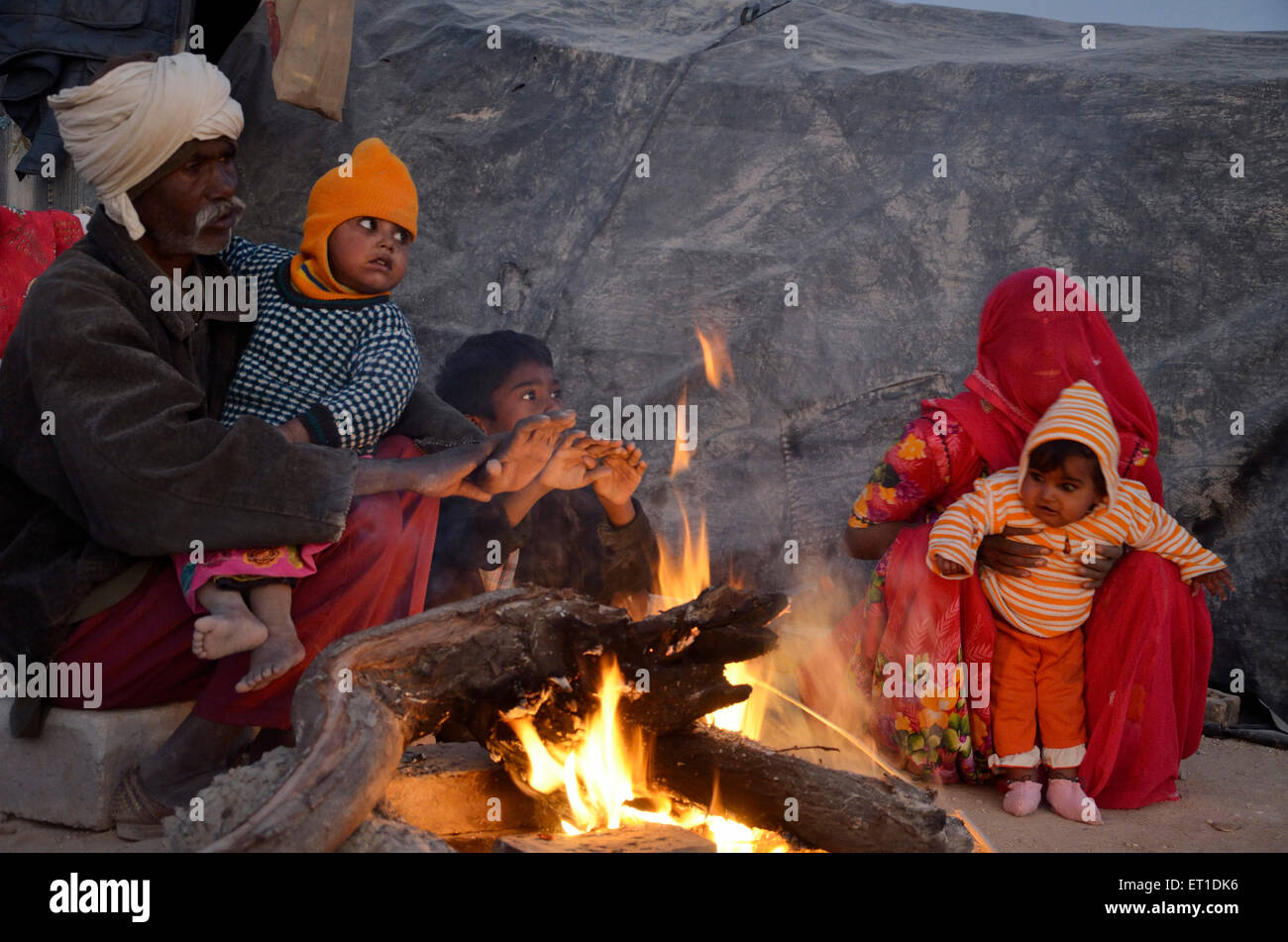 Man and Woman with Childs Warming Bikaner Rajasthan India Asia Stock Photo