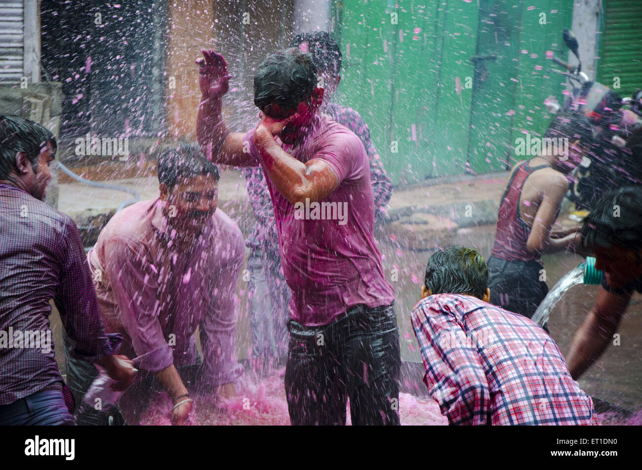 People pouring water with colour in Holi festival  Jodhpur at Rajasthan India Stock Photo