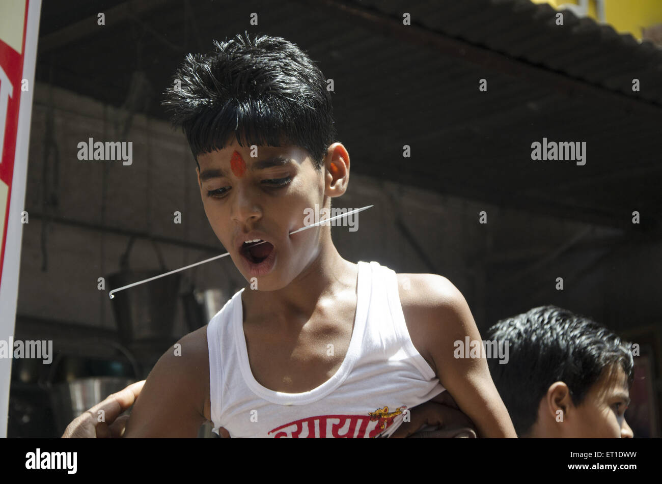 boy pierced cheek with needle in Jodhpur at Rajasthan India Stock Photo