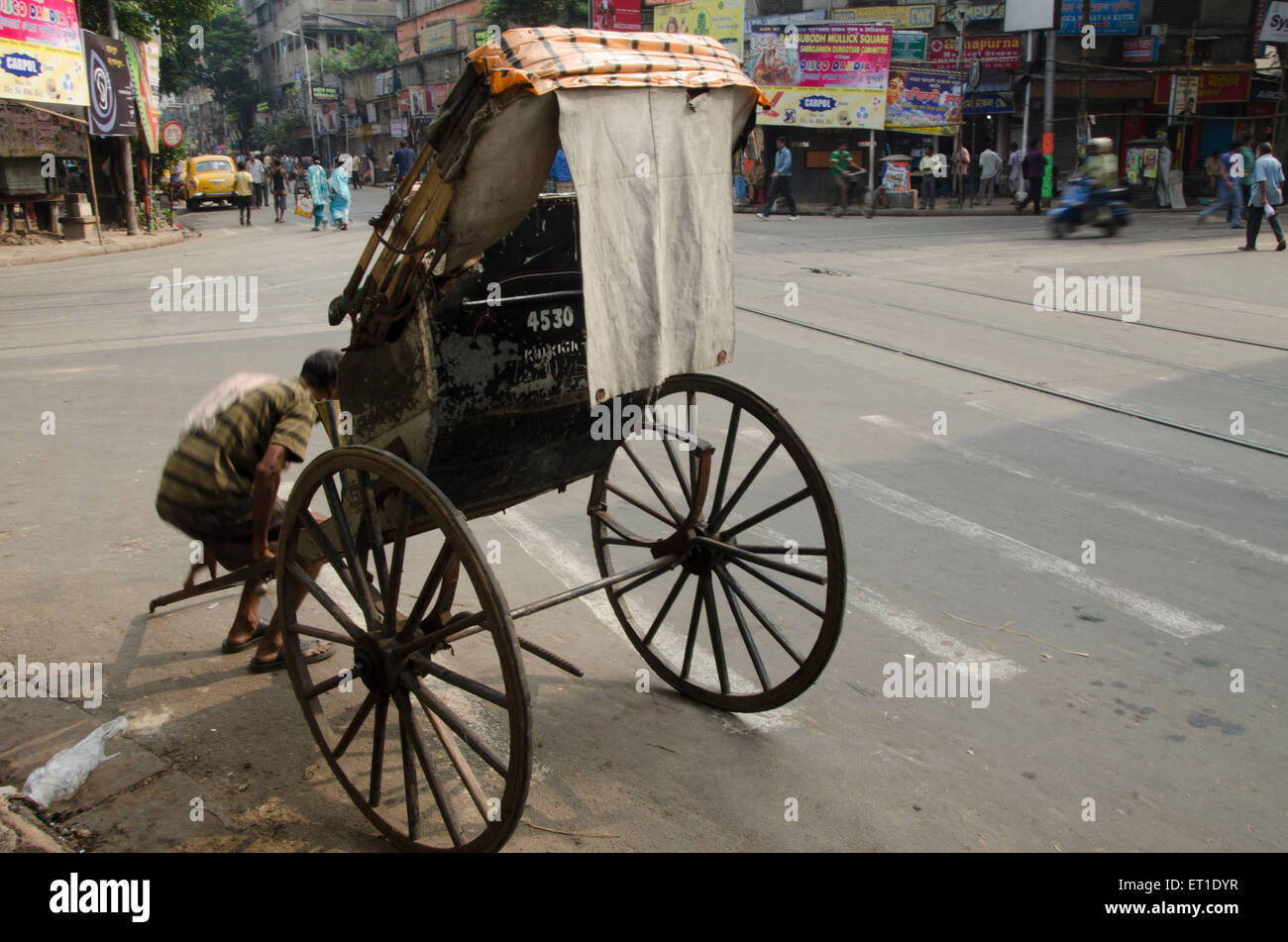 Hand rickshaw puller taking rest Kolkata West Bengal India Asia Stock Photo