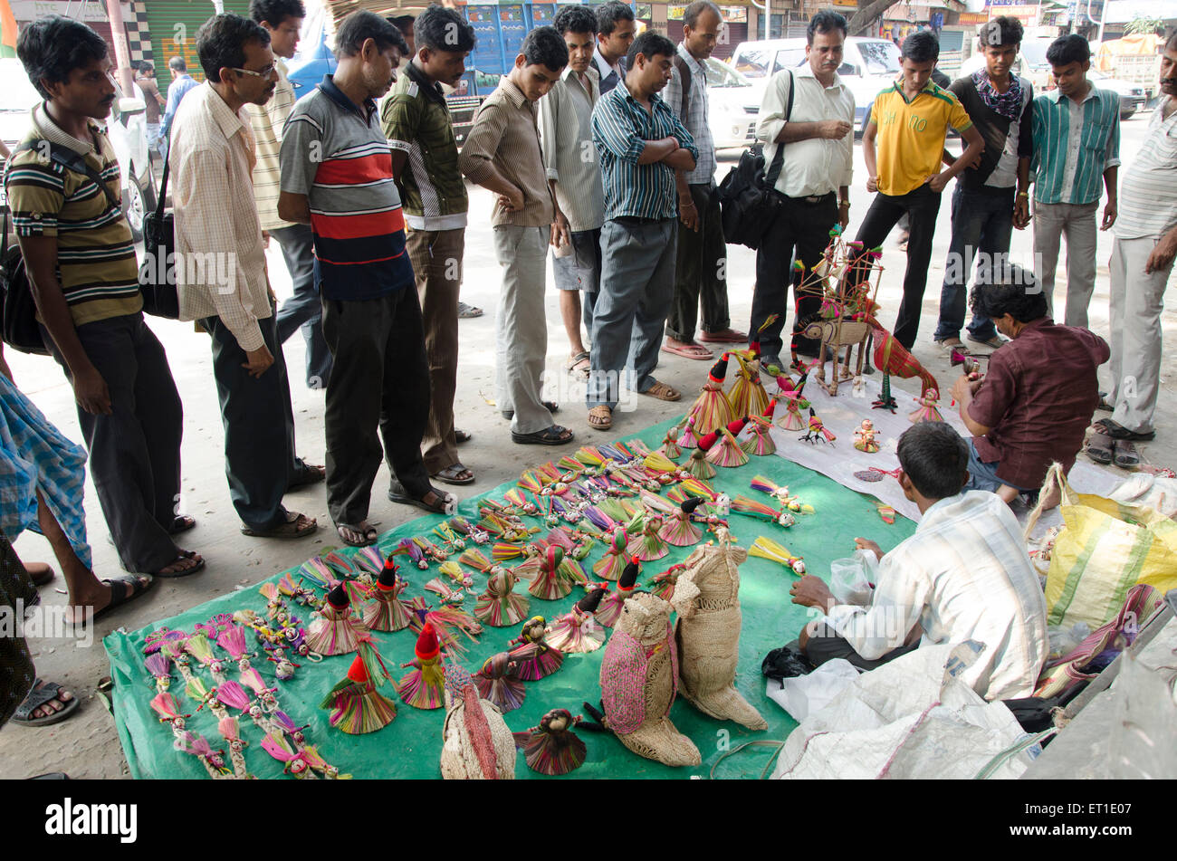 Man making and selling dolls on street Kolkata West Bengal India Asia Stock Photo