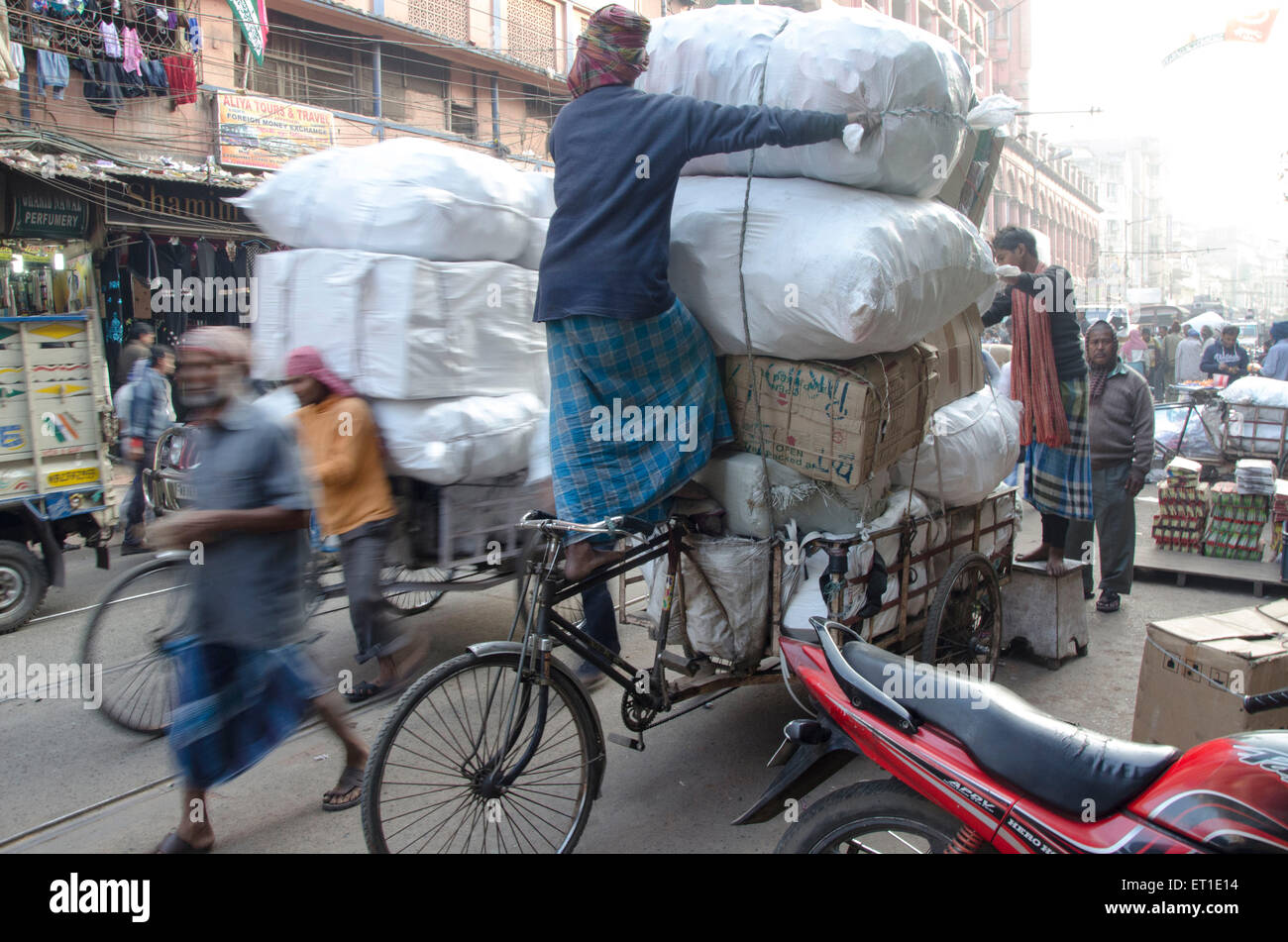 Worker putting on cycle rickshaw Kolkata West Bengal India Asia Stock Photo