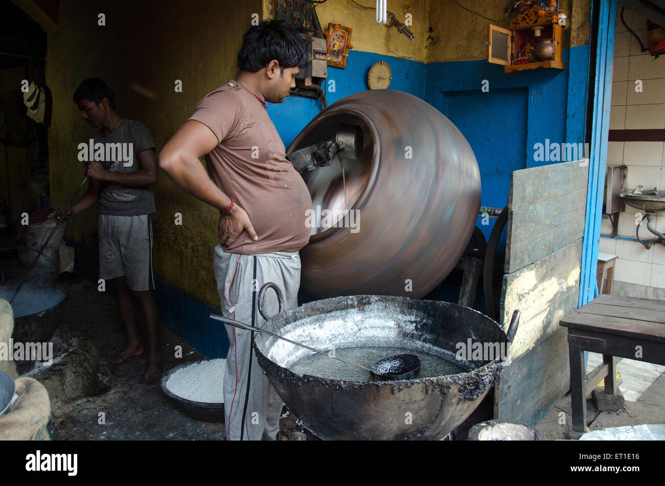Man making sweet liquid sugar Kolkata West Bengal India Asia Stock