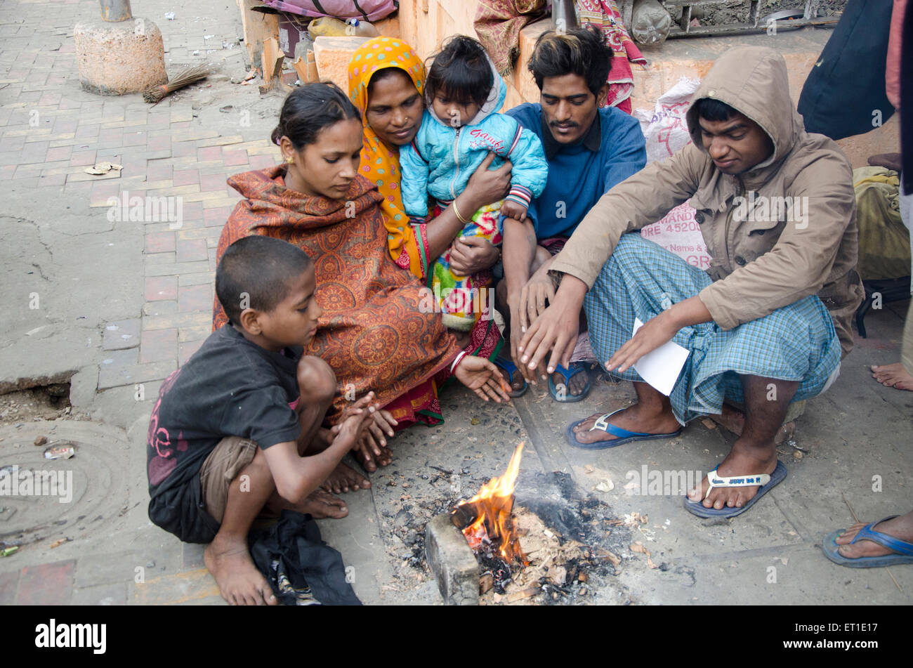 peoples warming hands over fire Kolkata West Bengal India Asia Stock Photo