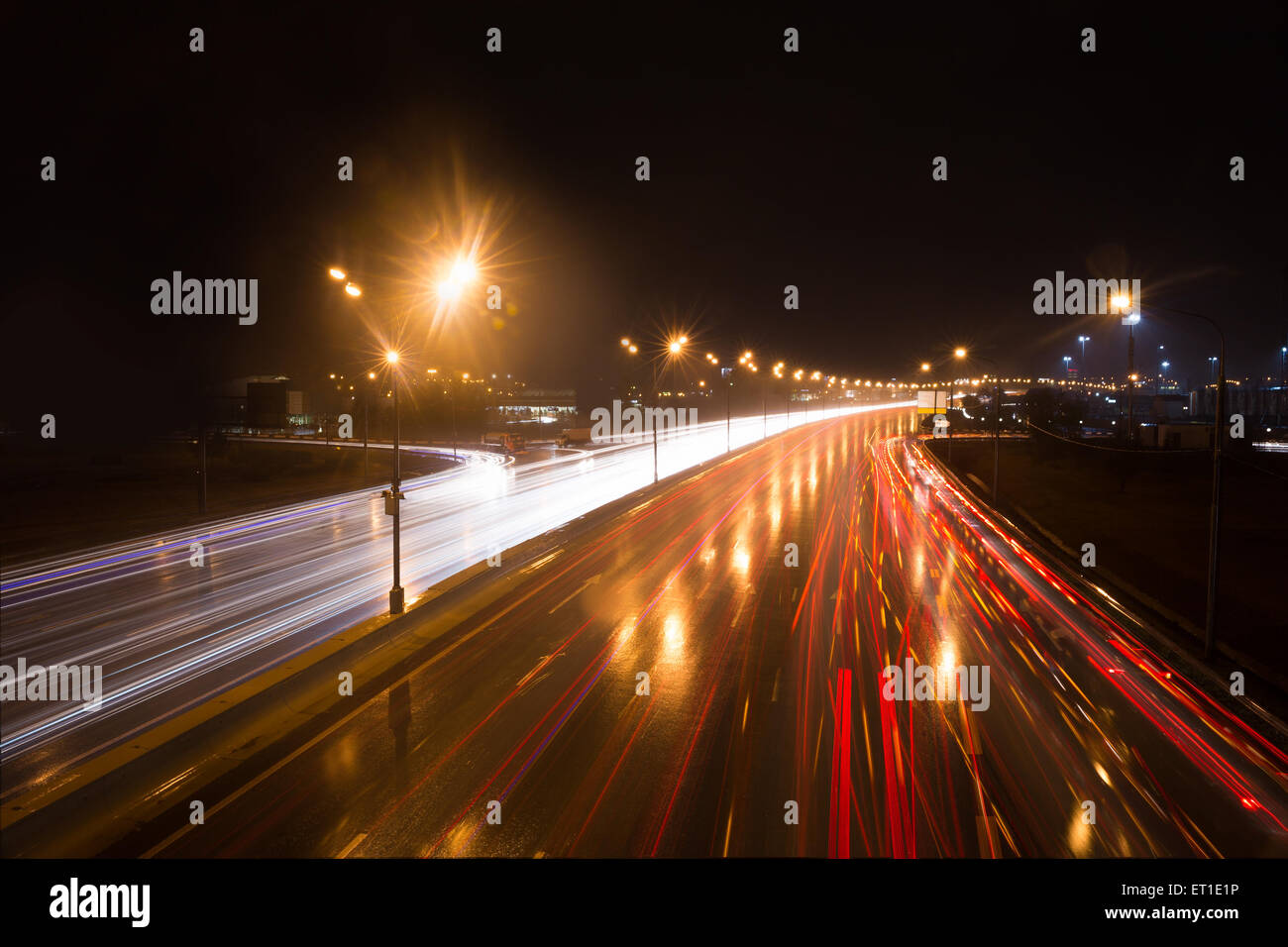 Illuminated highway at night with light trails Stock Photo