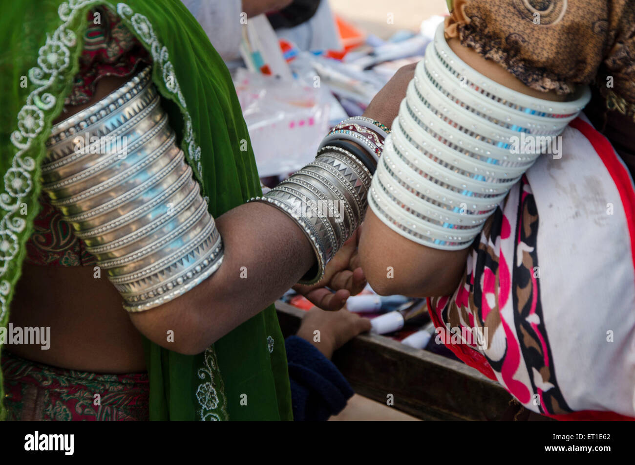 Tribal women wearing traditional bangle on arms Ahmedabad Gujarat India Asia - shi 189849 Stock Photo