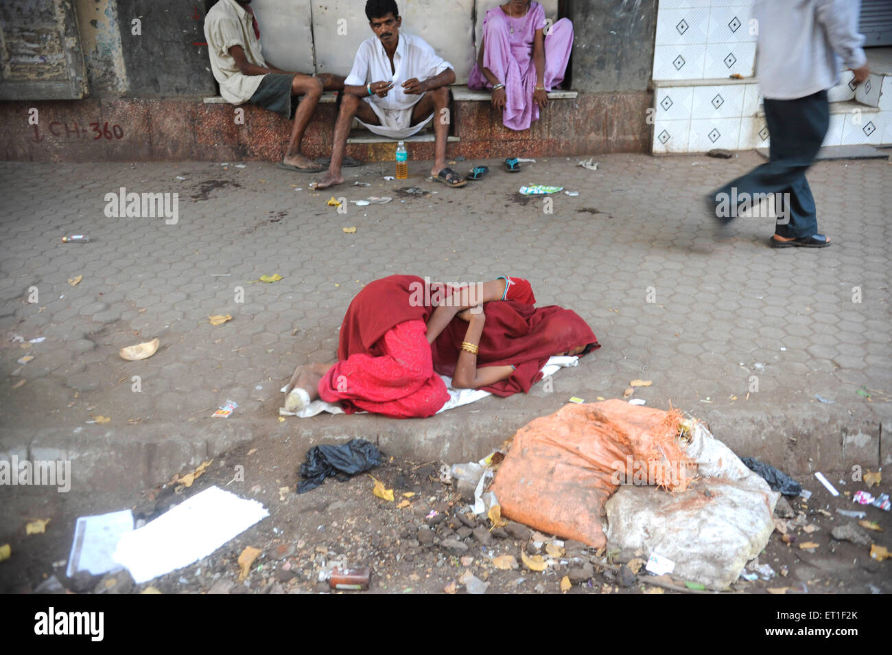 Woman sleeping on road ; Bombay Mumbai ; Maharashtra ; India Stock Photo
