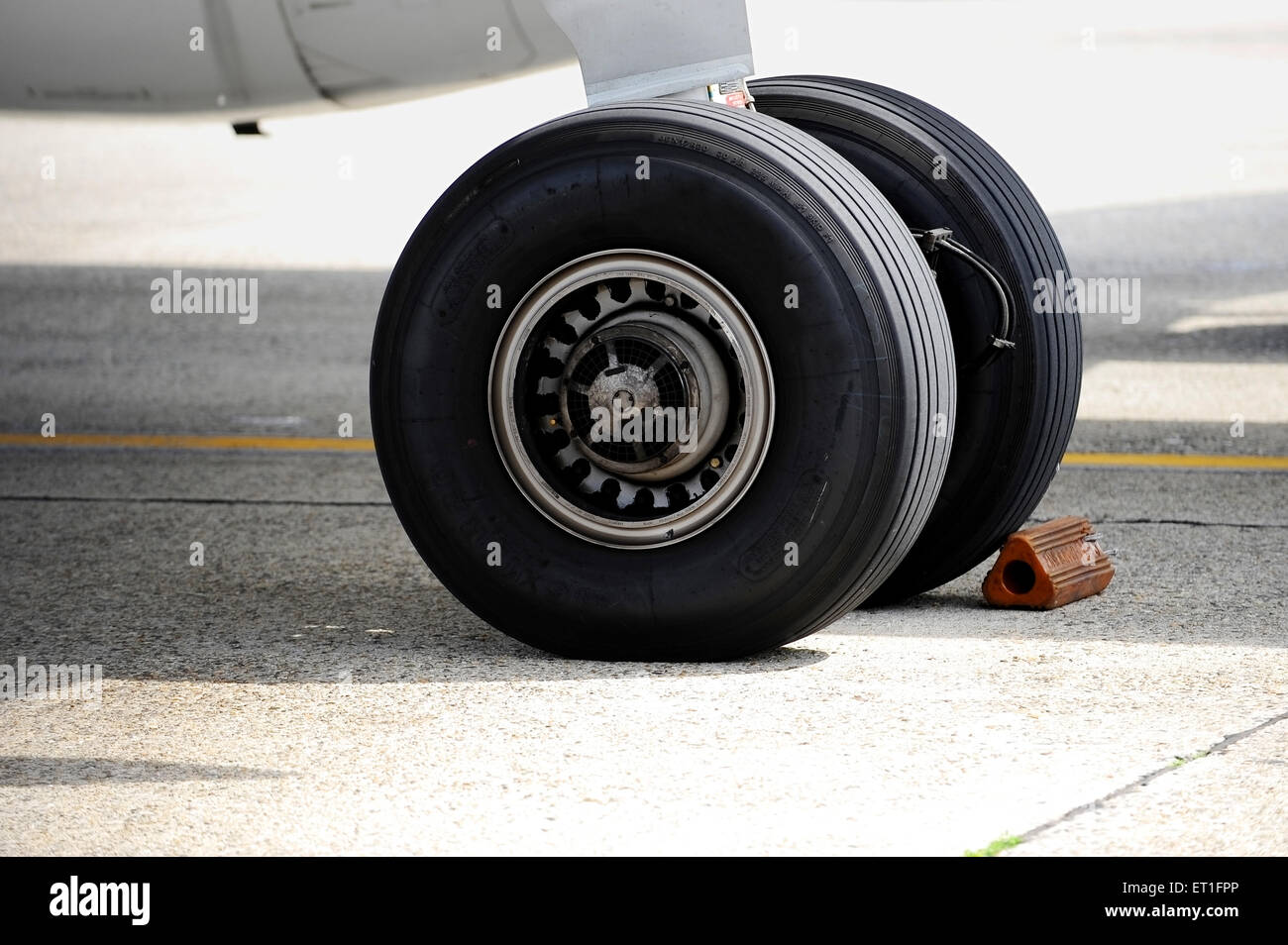 Detail shot with big airplane wheels and landing gear Stock Photo