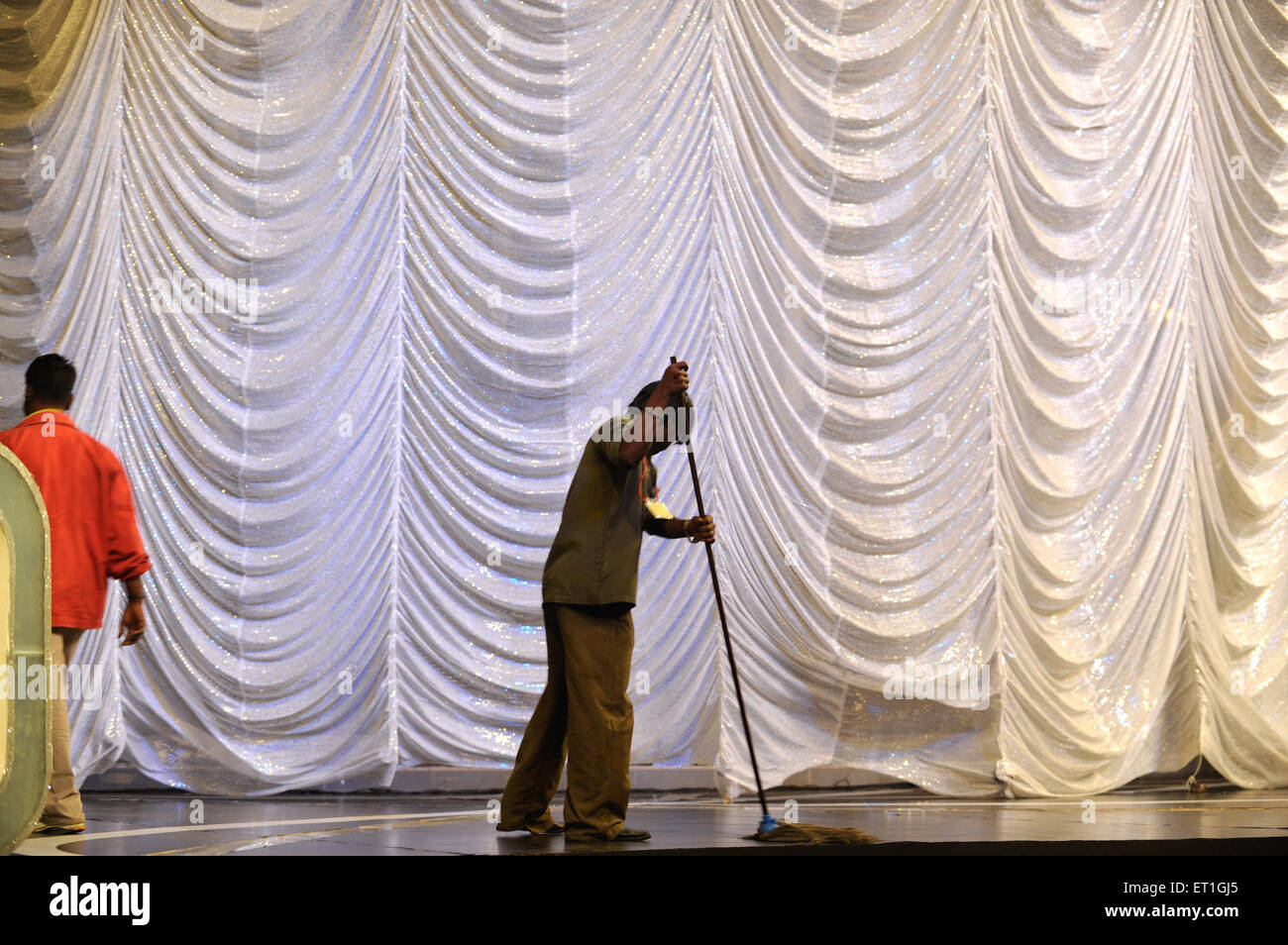 man mopping stage floor, Bombay, Mumbai, Maharashtra, India, Asia Stock Photo