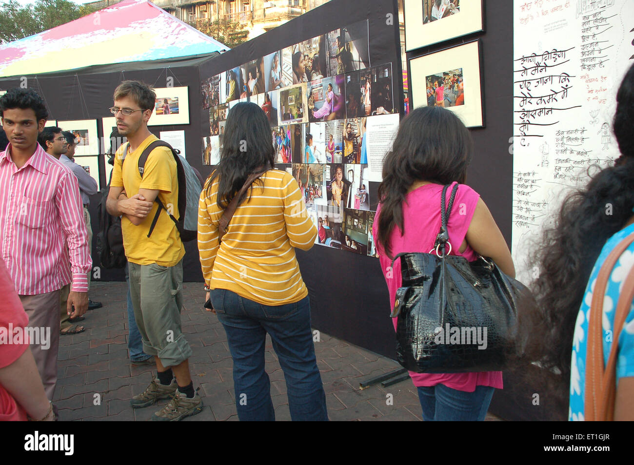 People enjoying exhibition at kala ghoda art festival ; Bombay Mumbai ; Maharashtra ; India NO