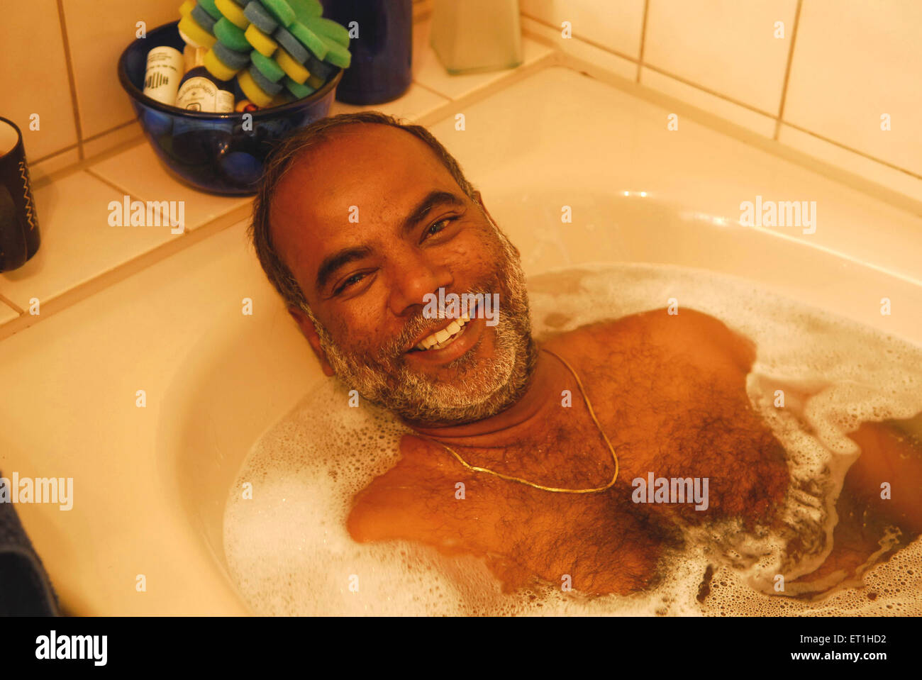 Sudharak Olwe photographer soaking in bath tub, India MR#400 Stock Photo