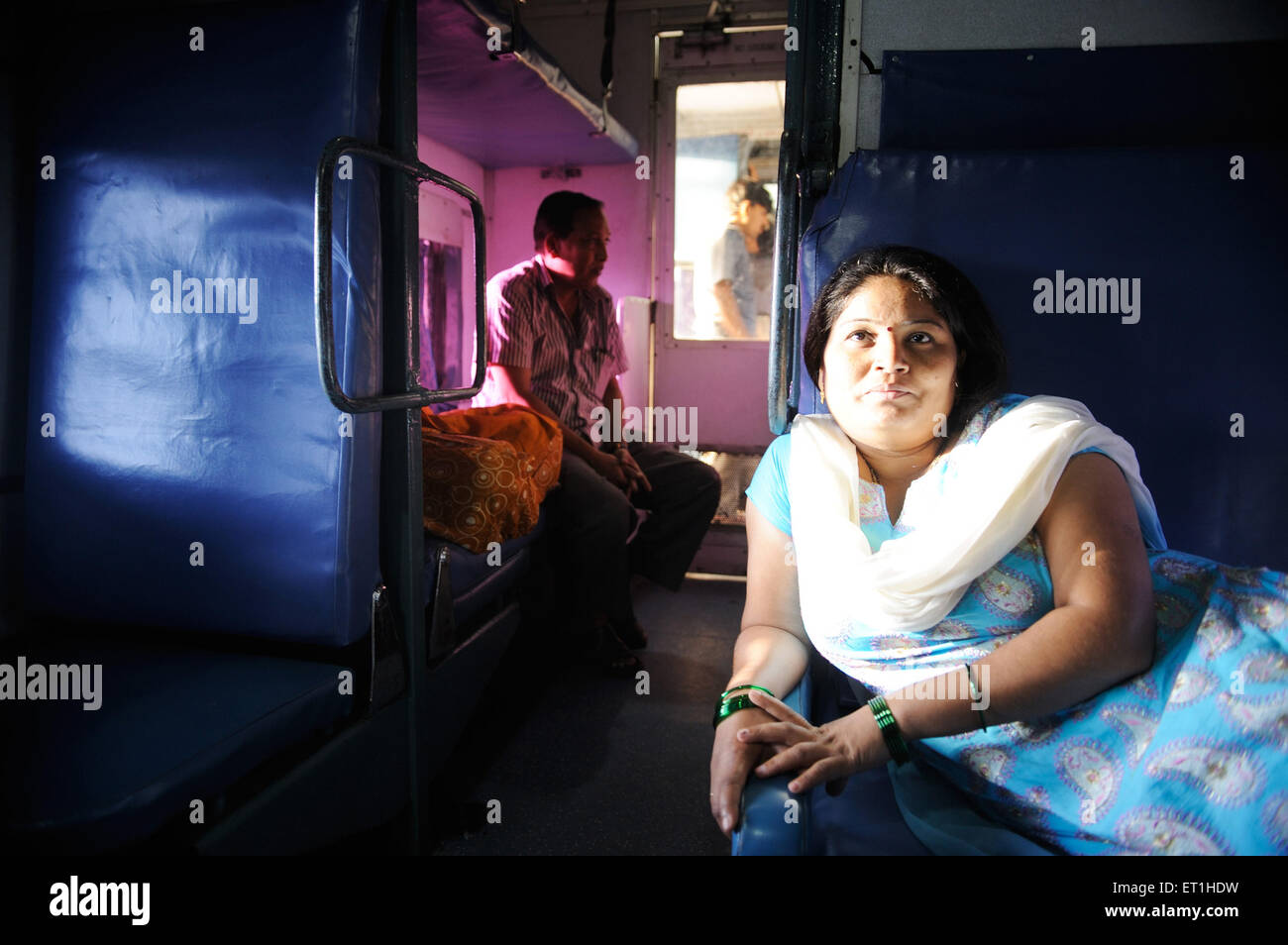 Woman sitting in train, Jammu, Kashmir, Jammu and Kashmir, Union Territory, UT, India, Asia, Asian, Indian, MR#400 Stock Photo