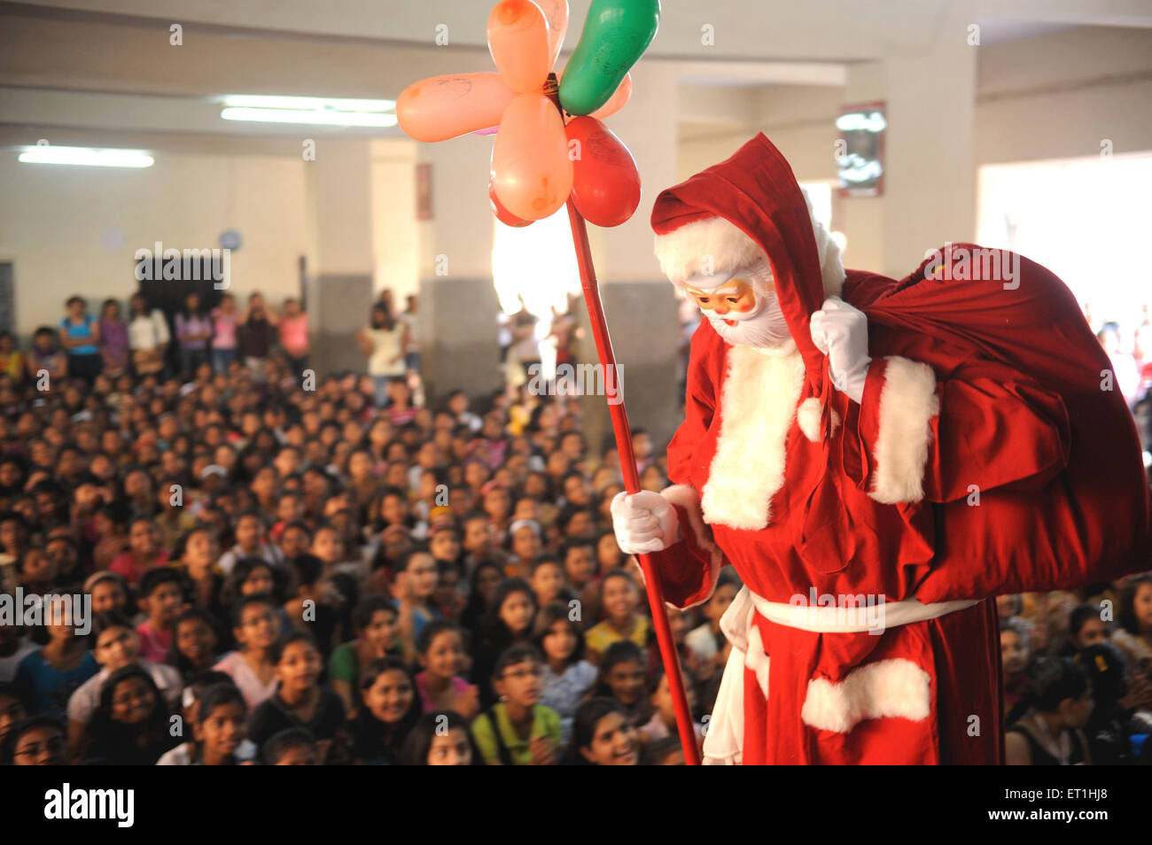 Santa claus coming around children ; Bombay Mumbai ; Maharashtra ; India NO MR Stock Photo