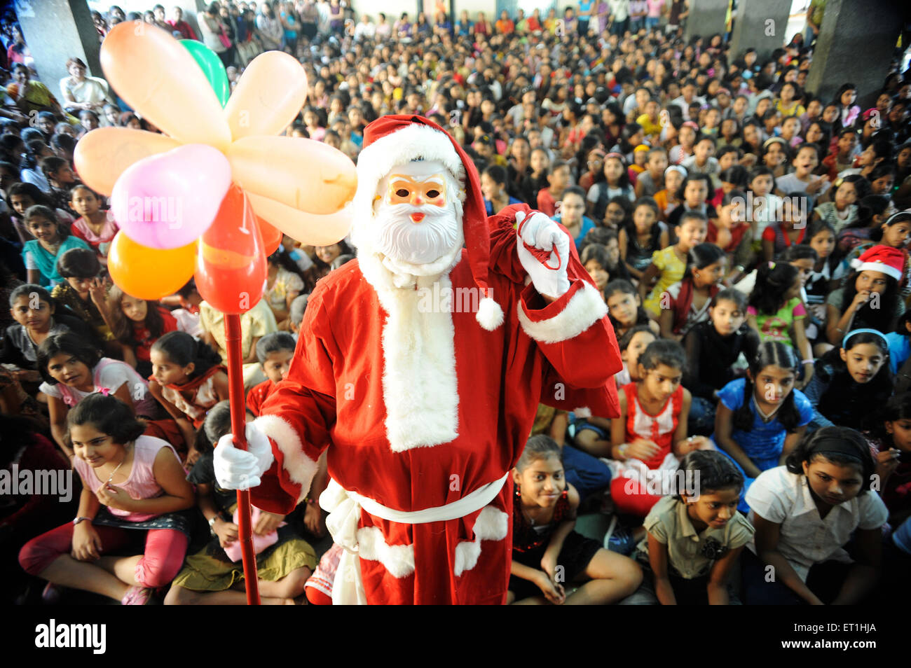 Santa claus coming around children ; Bombay Mumbai ; Maharashtra ; India NO MR Stock Photo
