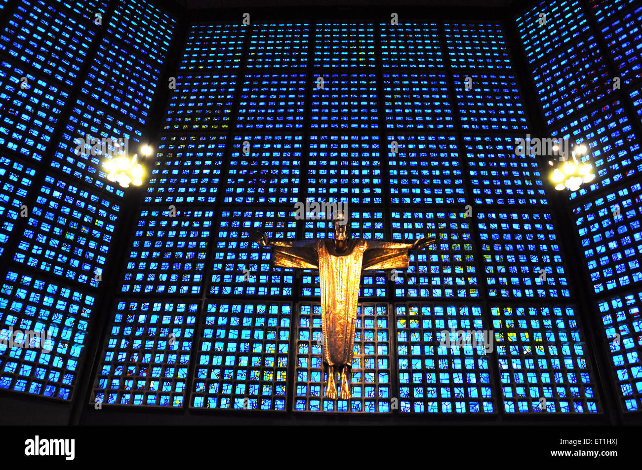 Gold statue of Christ against blue stained glass in the Kaiser Wilhelm Memorial Church in Berlin Stock Photo