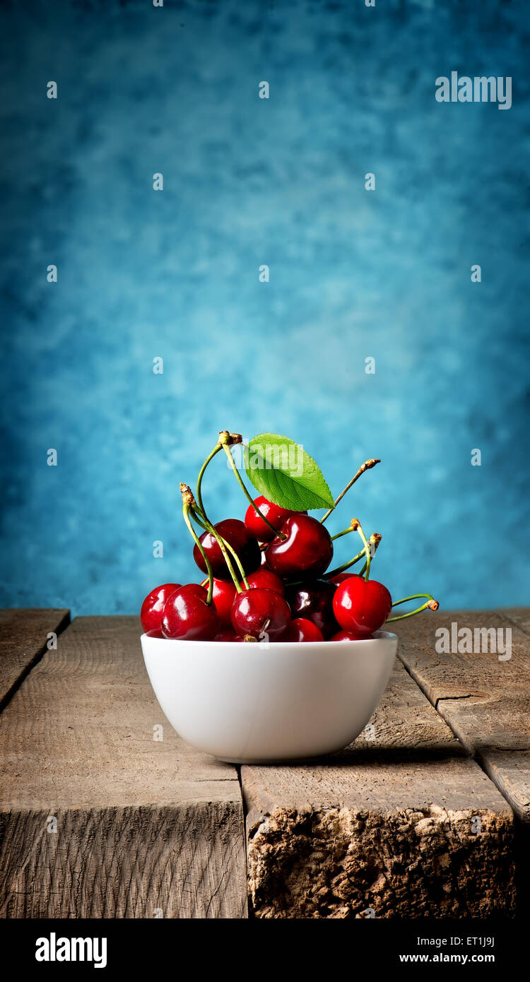 Plate of cherries on wooden table hi-res stock photography and images ...