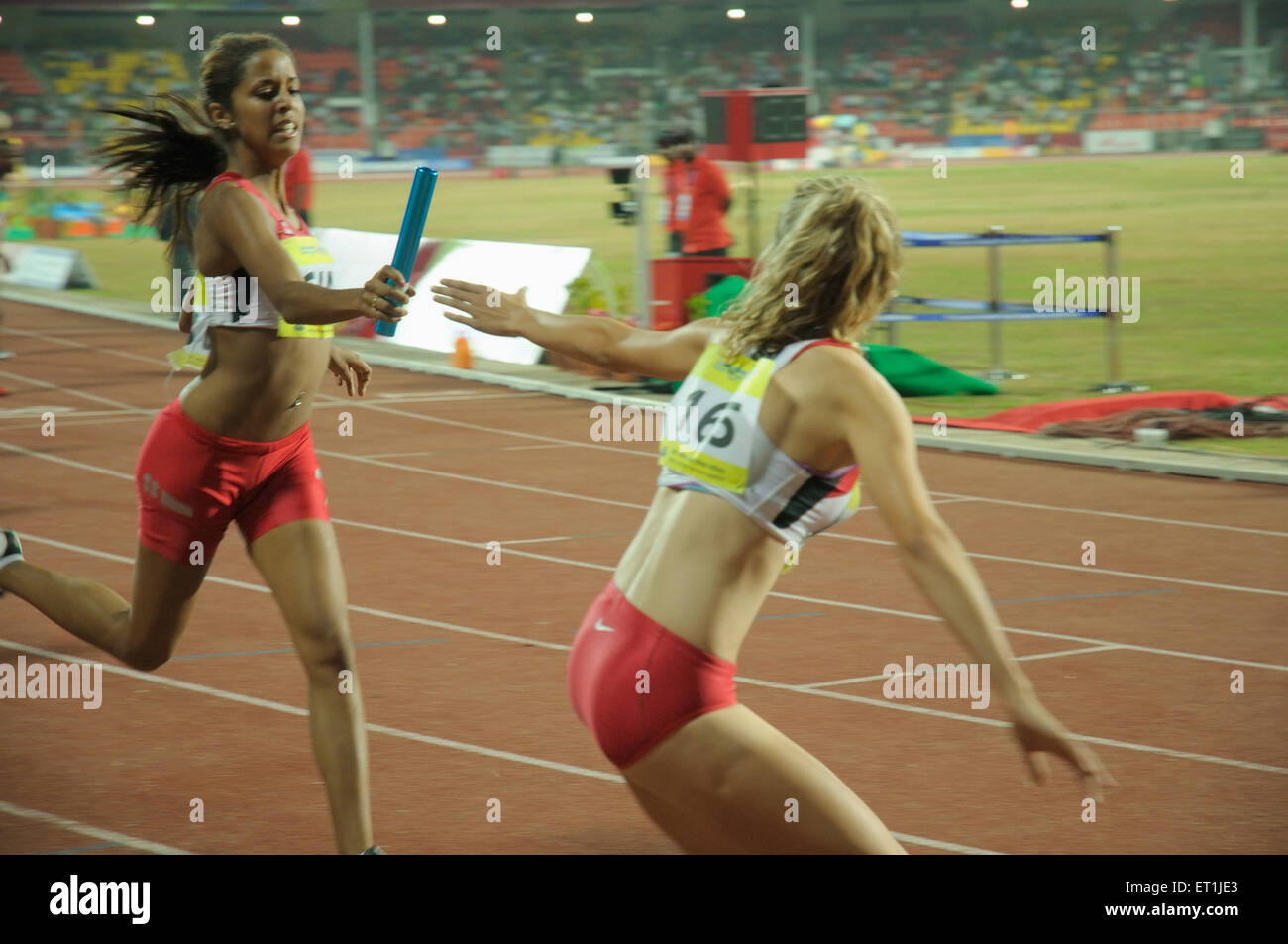 athlete passing baton, athletes running, sportswomen running, track and field, sports competition, Pune, Maharashtra, India, Asia, Asian, Indian Stock Photo