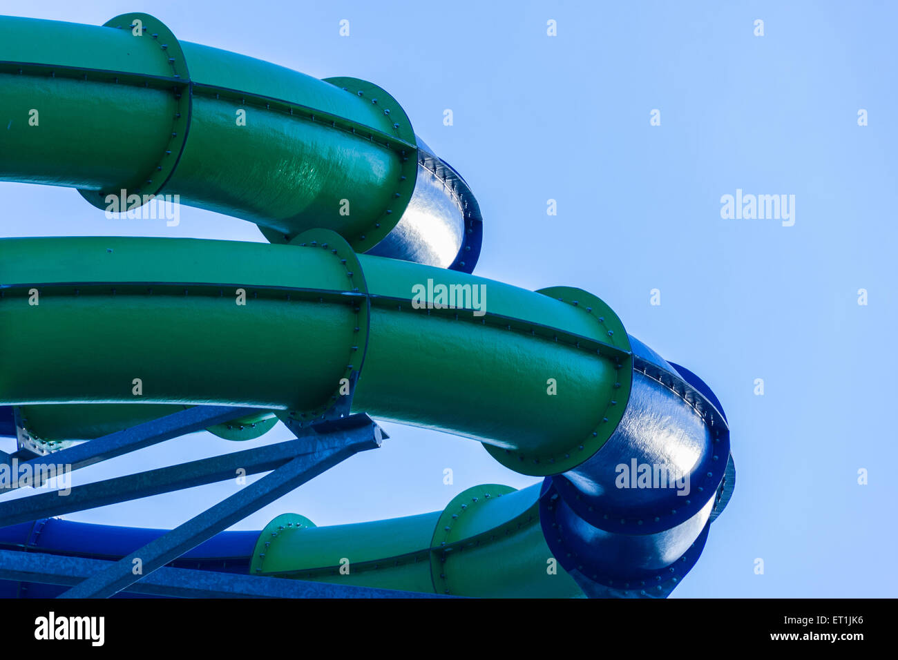 Tube spiral sections at water amusement park with blue sky. Stock Photo