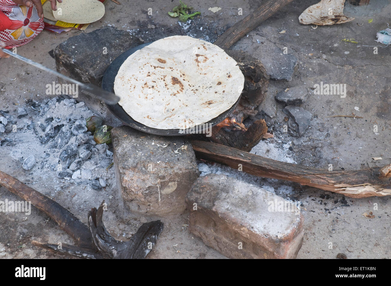 Roti roasted on hot pan open kitchen Siddhatek Maharashtra India Asia Asian Indian bread Stock Photo