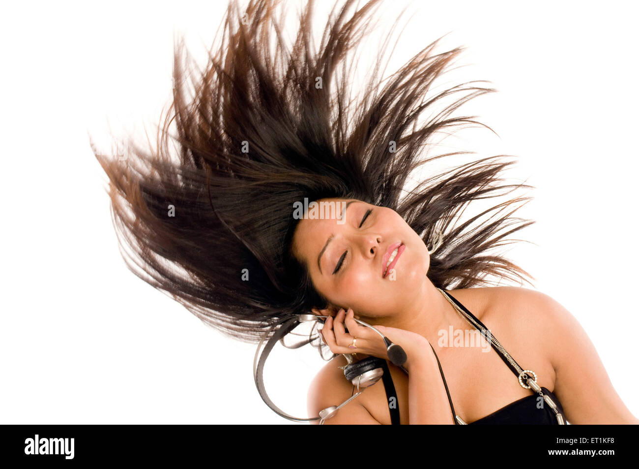South Indian girl wearing black halter neck top and listening music in Pune at Maharashtra India Asia MR#686X Stock Photo