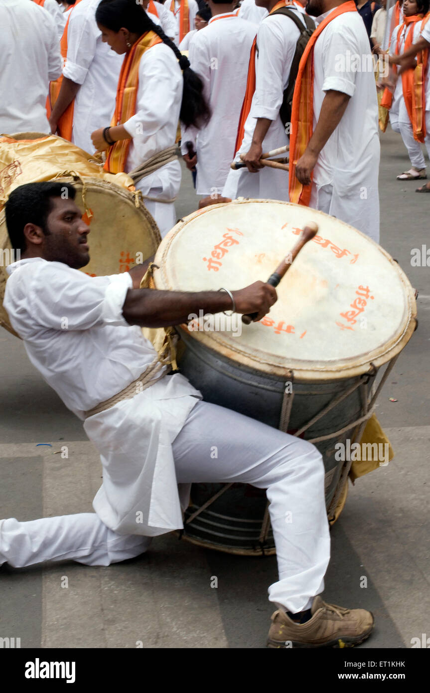 man playing musical instrument Dhol in Ganesh festival in pune at