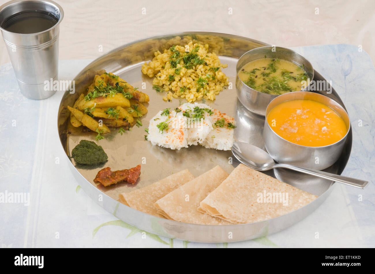 Gujarati food including various items steel plate Pune Maharashtra India Asia May 2011 Stock Photo