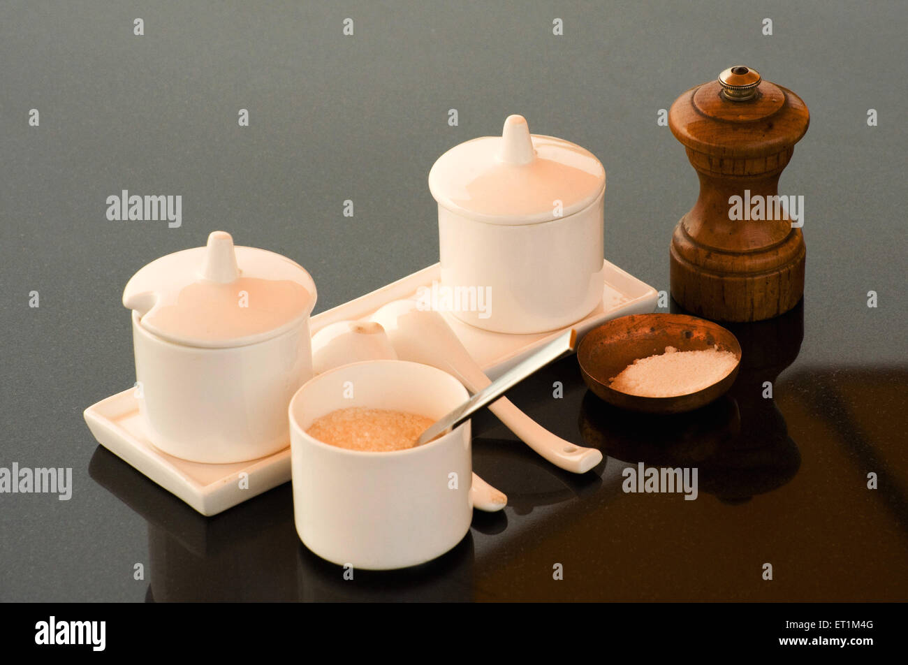 Salt pepper shaker and sugar on gray background Stock Photo