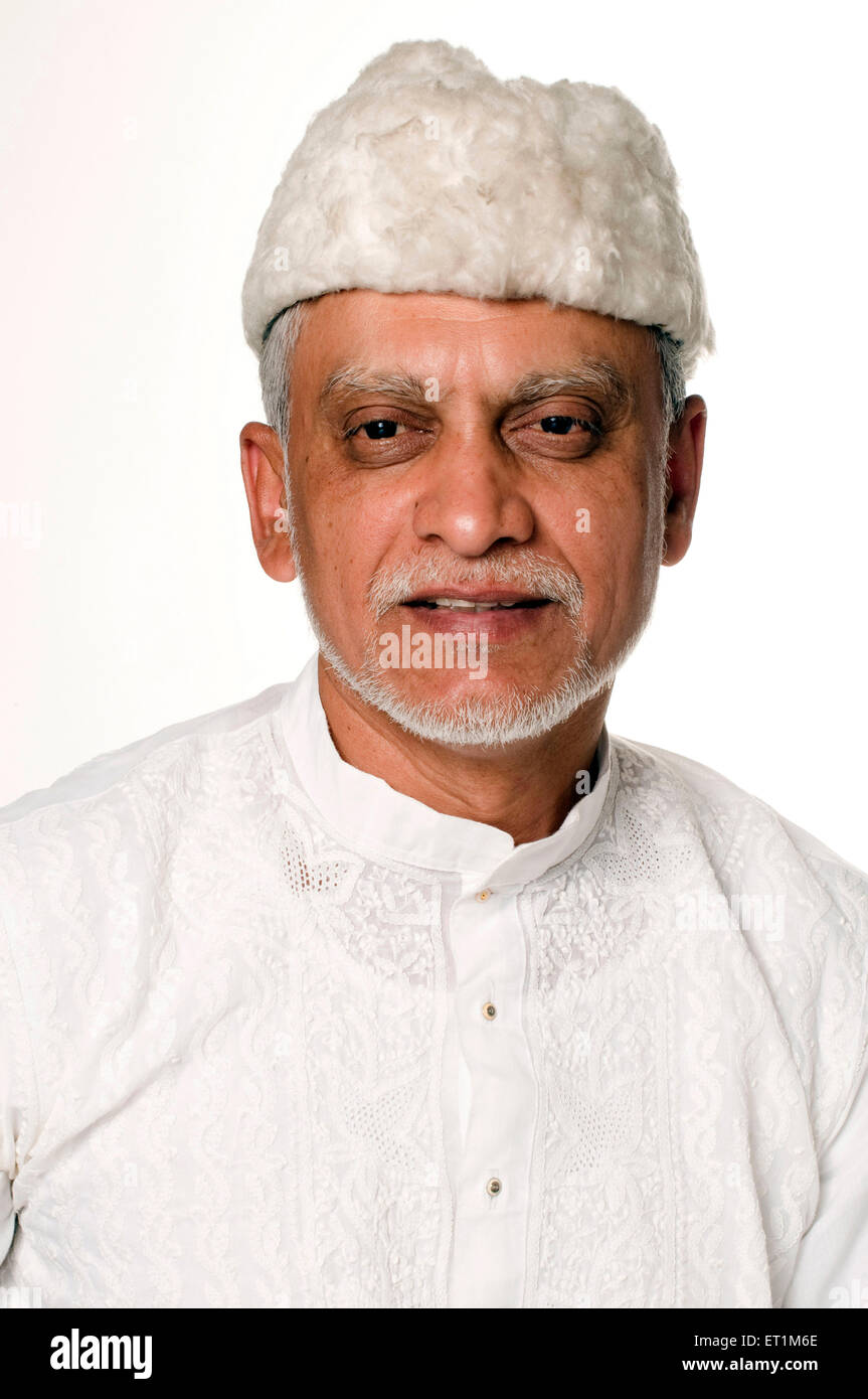 Portrait of Maharashtrian elderly man wearing white kurta and furry cap Pune Maharashtra India MR # 686P Stock Photo