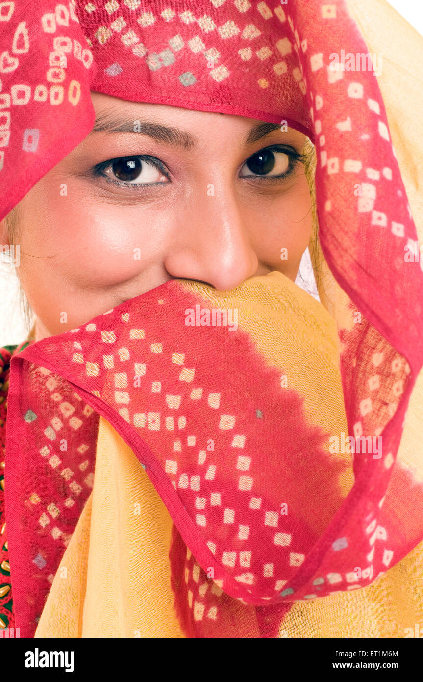 A portrait of maharashtrian girl covering her mouth with a odhni Pune Maharashtra India Asia MR # 686EE Stock Photo