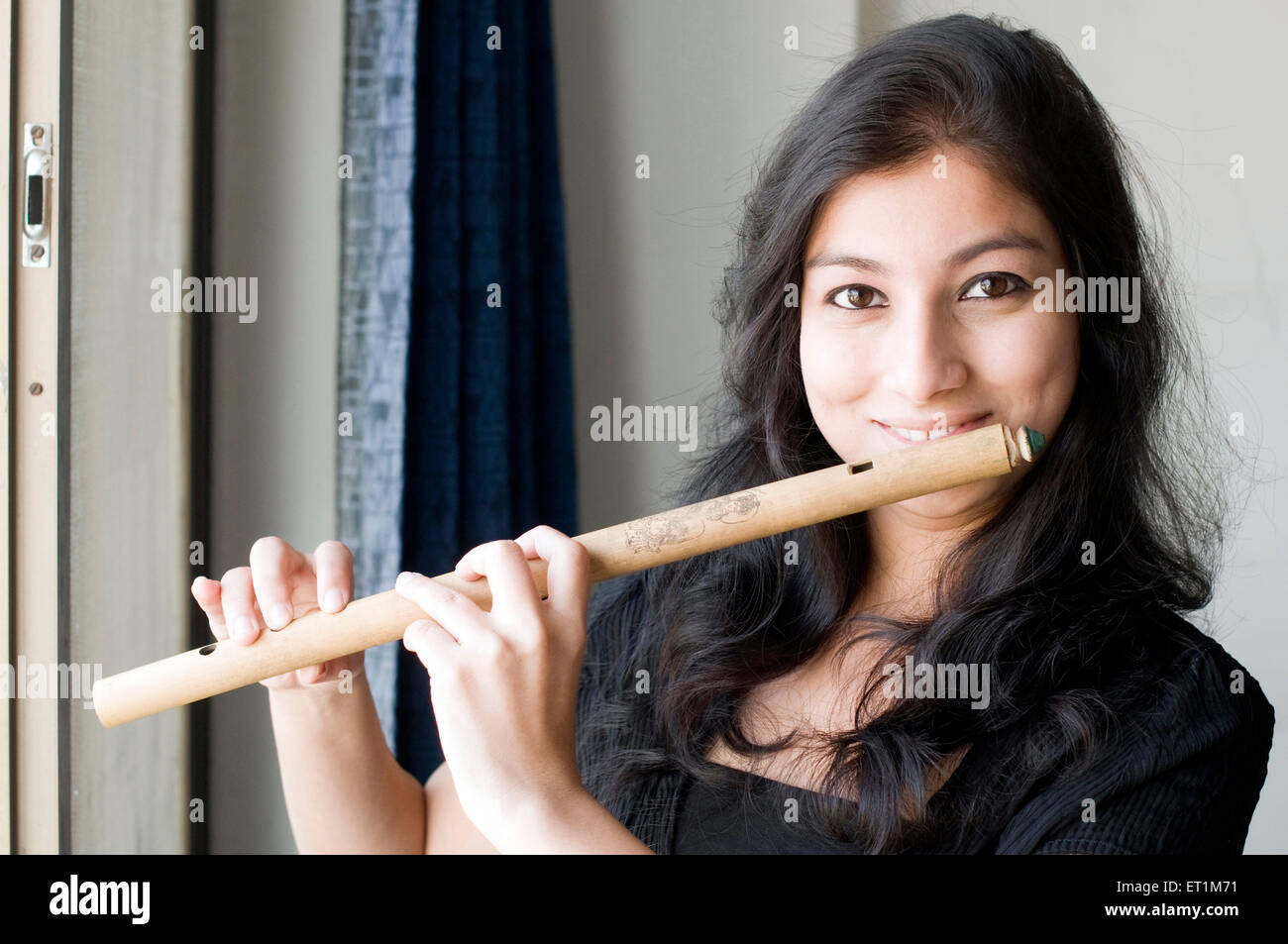 A portrait of maharashtrian girl playing a flute Pune Maharashtra India