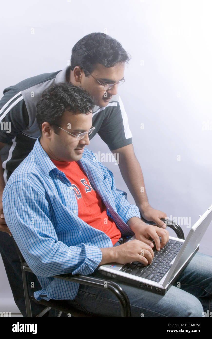 Two young men working on laptop ; India MR#556 Stock Photo - Alamy