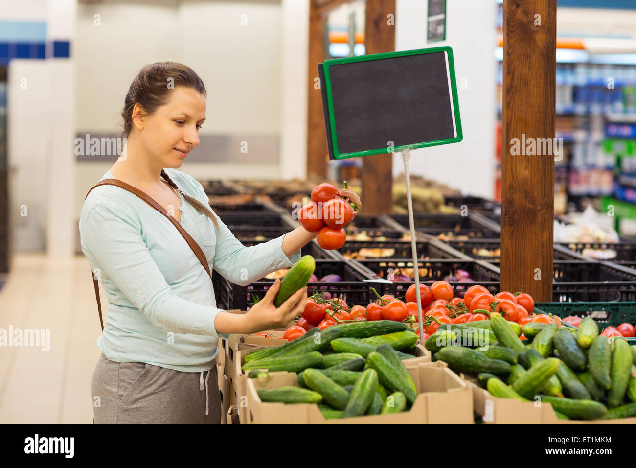 Beautiful young woman shopping for cereal, bulk in a grocery supermarket Stock Photo