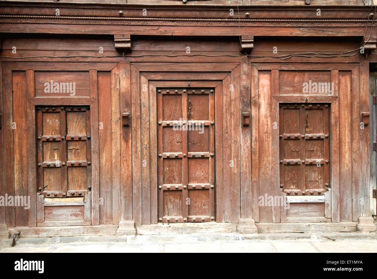 Closed wooden door and windows of old house, Junnar village ; district Pune ; Maharashtra ; India ; Asia ; Indian ; Asian Stock Photo