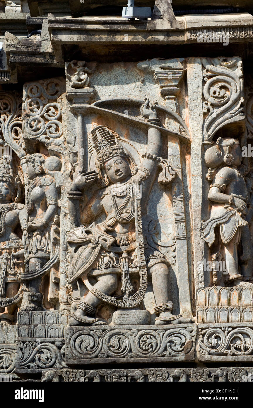 Arjun with bow and arrow carved on hoysaleswara temple ; Halebid Halebidu ; Hassan ; Karnataka ; India Stock Photo
