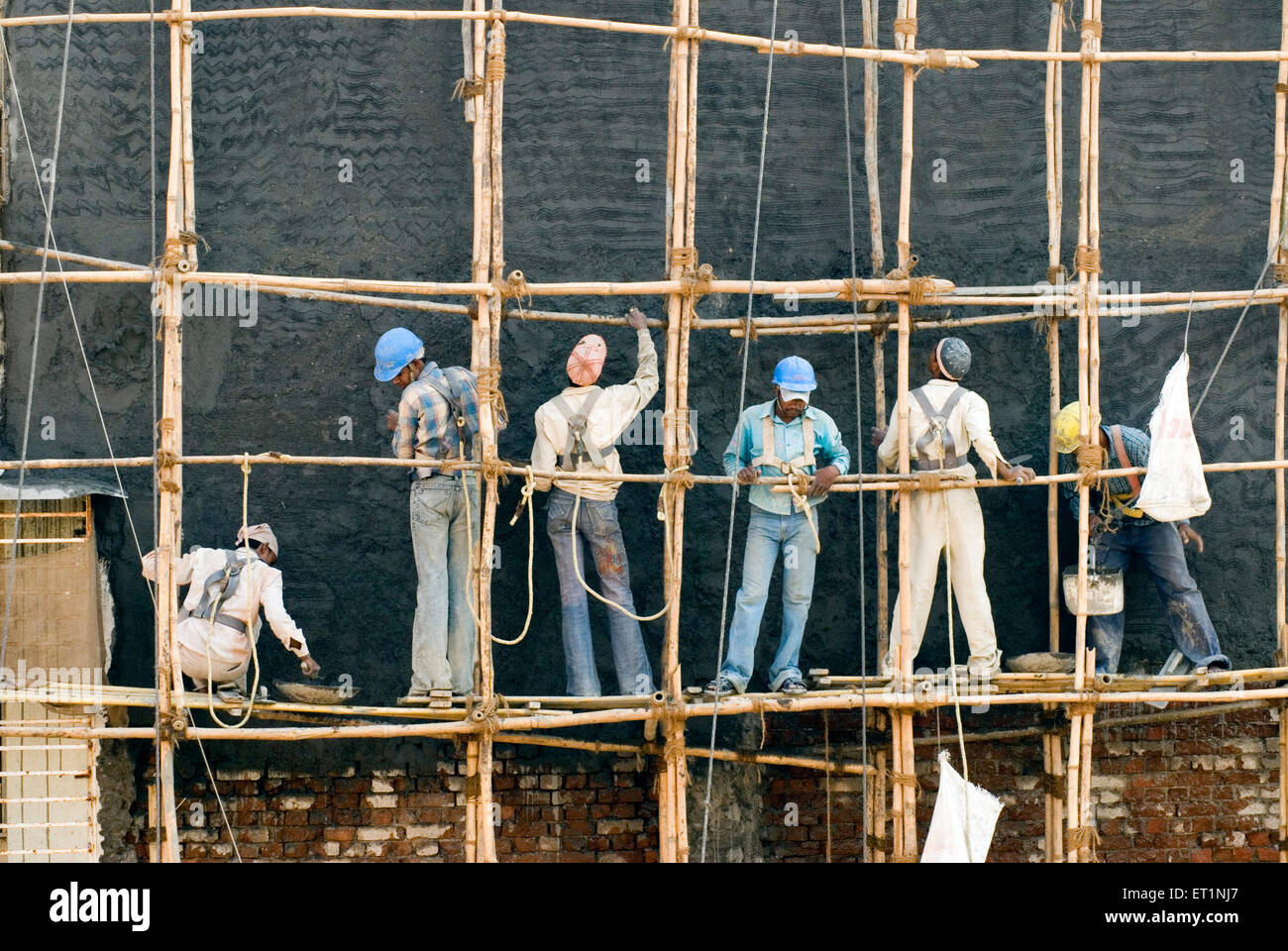 Construction workers bamboo scaffolding Bombay Mumbai  Maharashtra India Asia Stock Photo