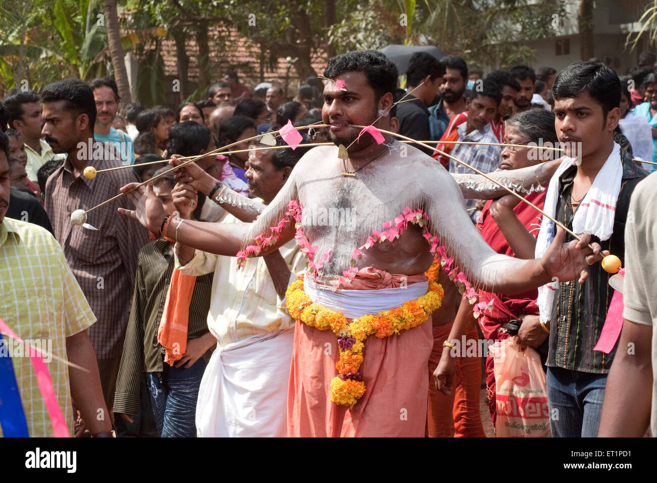 Man piercing spike through cheeks discharging vow in Thaipusam festival ; Kerala ; India NOMR Stock Photo