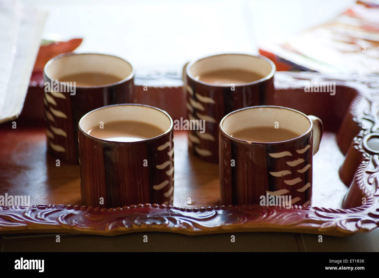 four tea cups in plastic tray Stock Photo