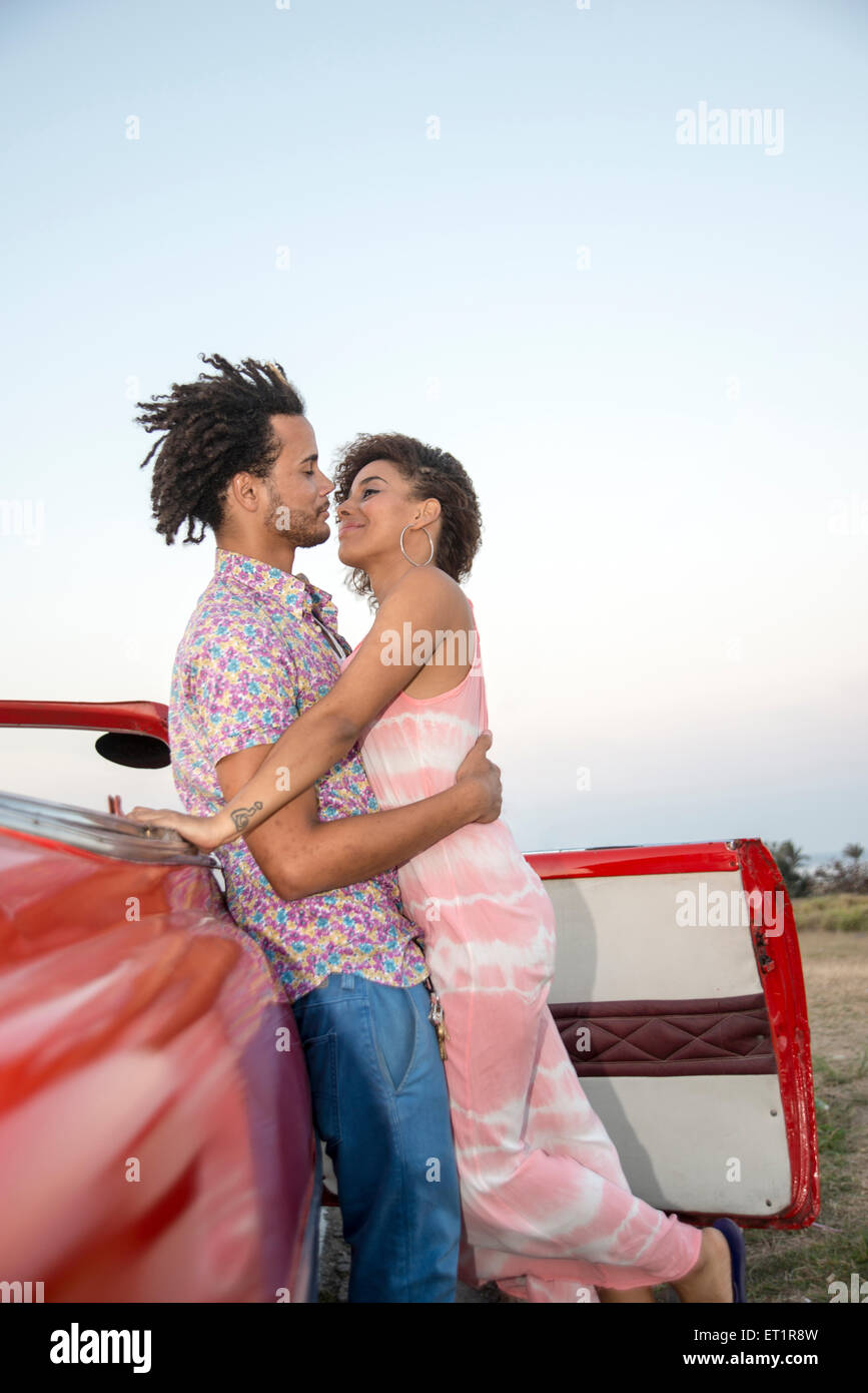 Lain couple in a classic car on sunset Stock Photo