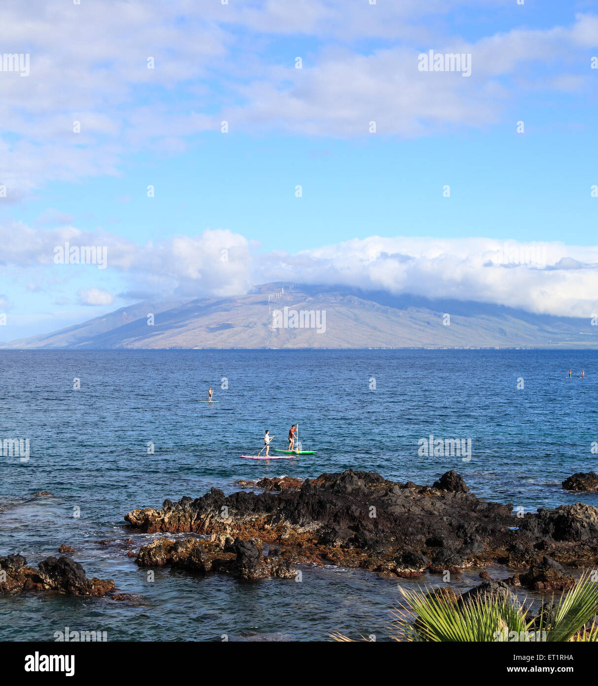 Stand up paddle boarders off Wailea, Maui, as seen from the beach walk Stock Photo