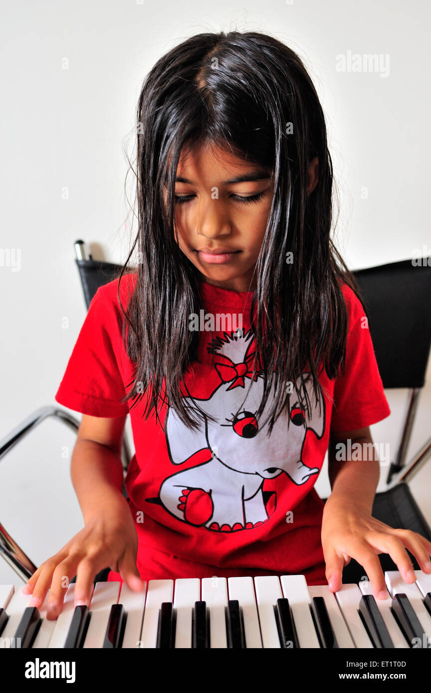girl child playing electronic musical instrument synthesizer MR#556 Stock Photo
