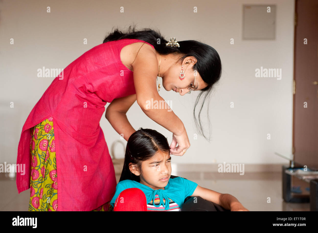 Mother combing hair of daughter MR#556 Stock Photo