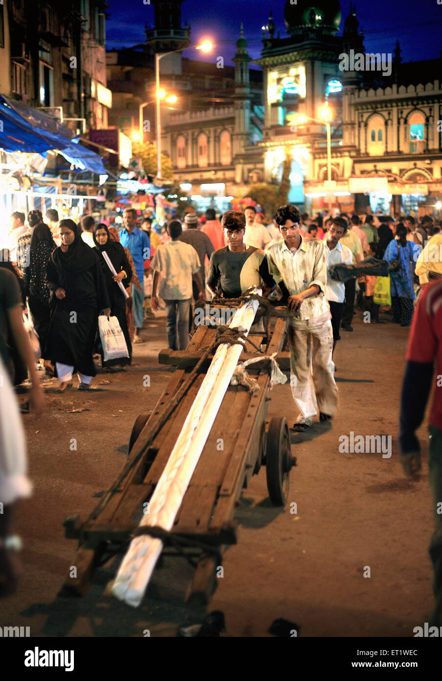 Labourer pulling cart at the Mohammed Ali road ; Bombay Mumbai ; Maharashtra ; India Stock Photo