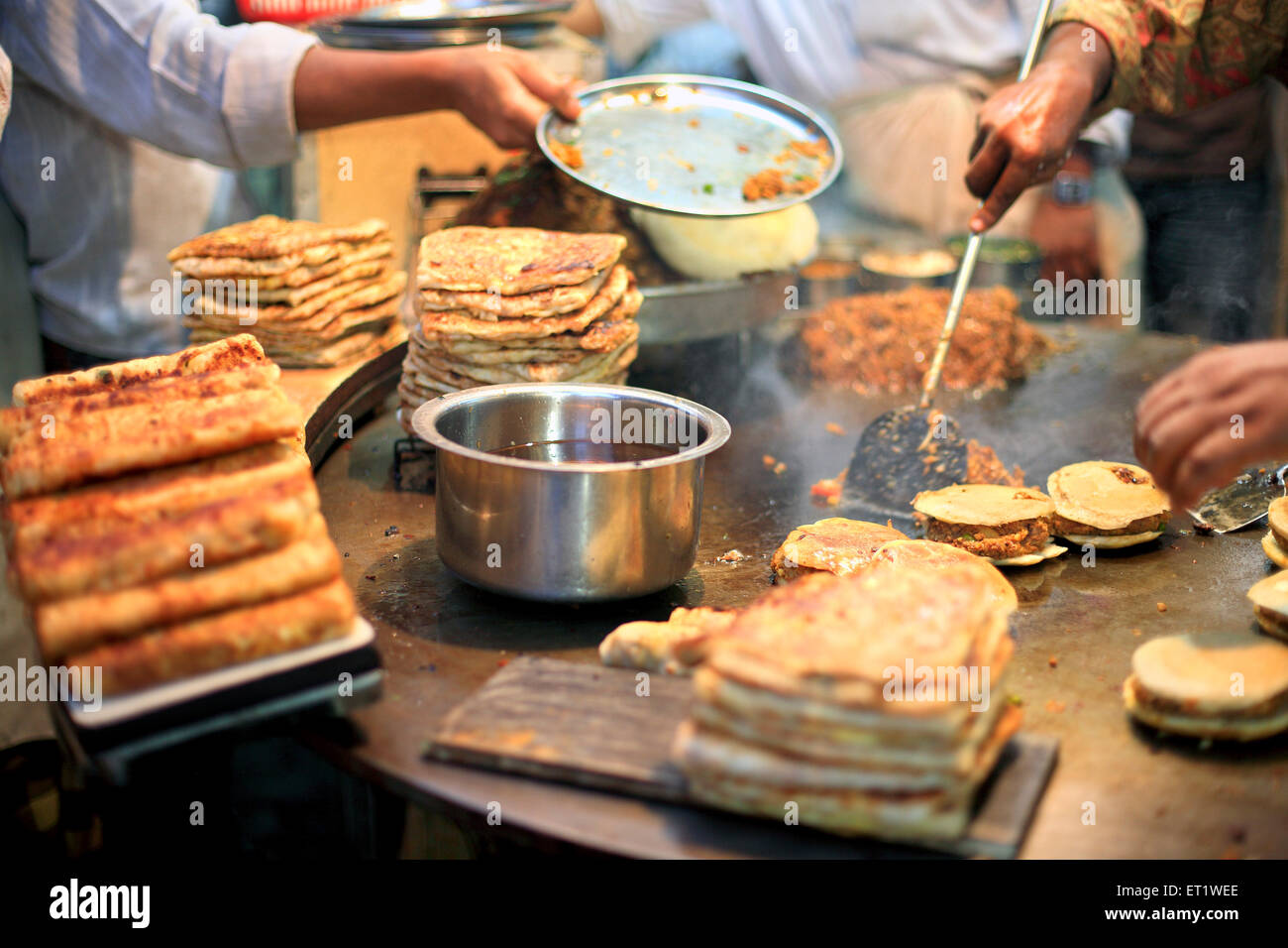 Chefs cooking Kheema Pav at a roadside restaurant on street during Ramzan ; Mohammed Aii road ; Bombay Mumbai ; Maharashtra Stock Photo