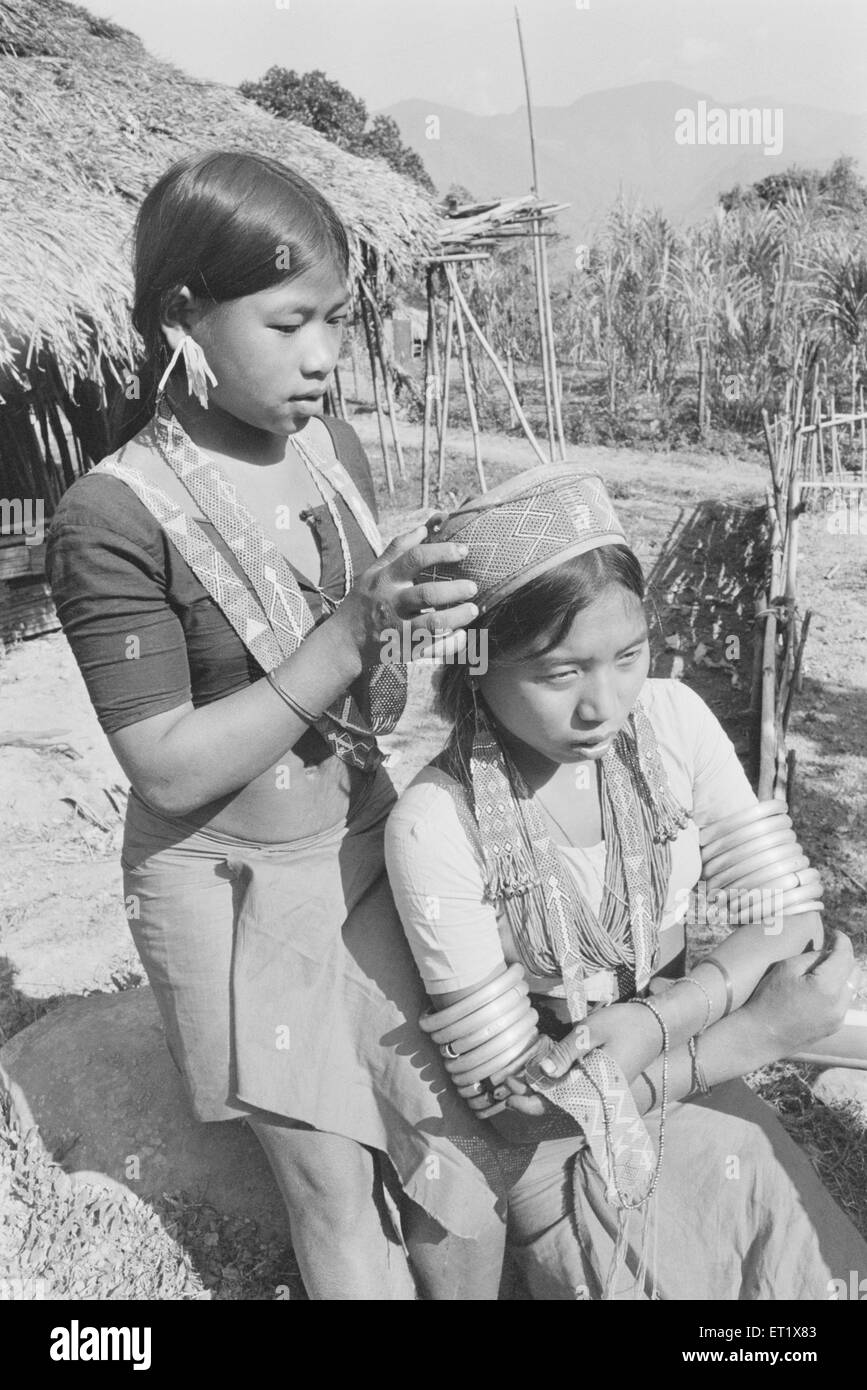 Wancho tribal girls dressing up for festival ; Tirap district ; Arunachal Pradesh ; India ; Asia ; old vintage 1900s picture Stock Photo