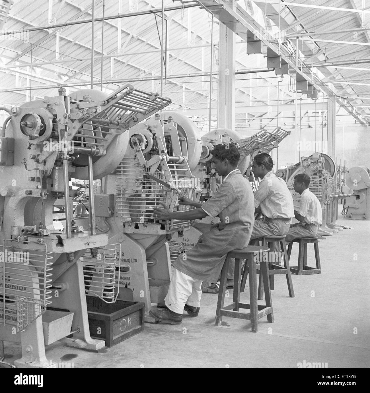 Workers at assembly line, telephone factory, telephone instruments manufacture, Bangalore, Karnataka, India, Asia, 1950, old vintage 1900s b & w image Stock Photo