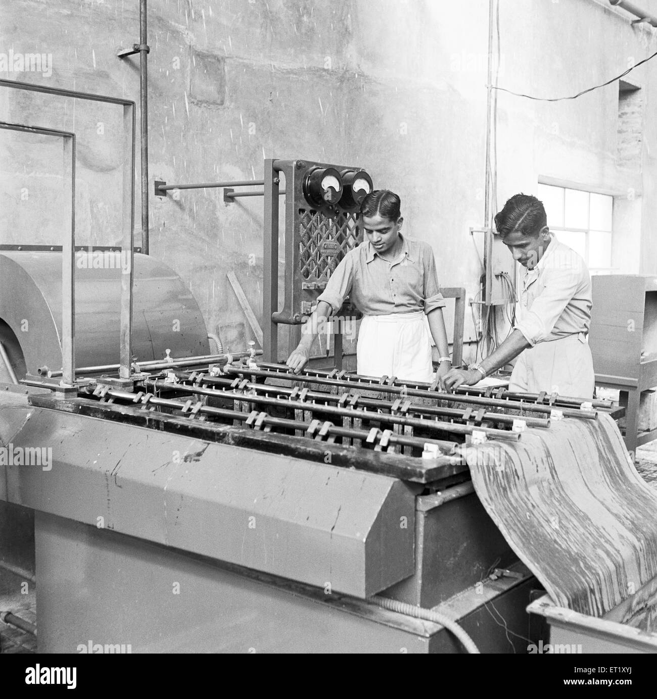 Workers at the assembly line ; telephone factory ; manufacturing of telephone instruments at Bangalore ; Karnataka ; India ; Asia ; old vintage 1900s Stock Photo