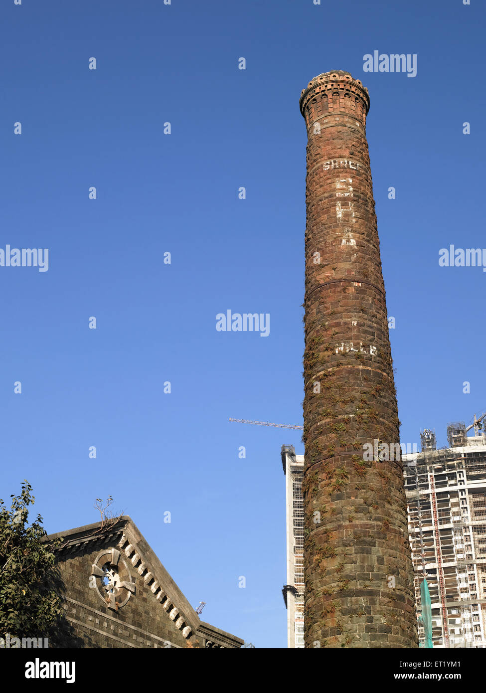 Old mill chimney and new building ; Bombay ; Mumbai ; Maharashtra ; India ; Asia Stock Photo