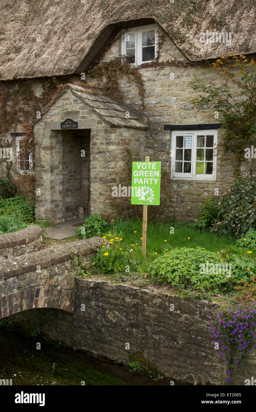 Vote green party. A political placard in a rural cottage garden supports the Green Party in the 2015 UK general election. Dorset, England, UK. Stock Photo