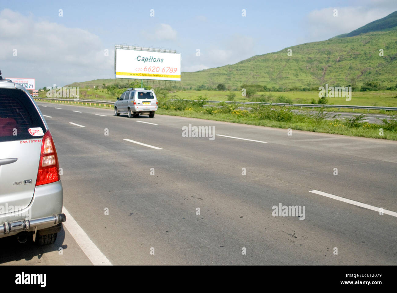 Two cars on Mumbai Pune express way ; Maharashtra ; India Stock Photo